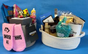 gift baskets filled with prizes for Library Card Sign-Up Month including a Kindle e-reader for adults/teens and a Toniebox audio player for kids.