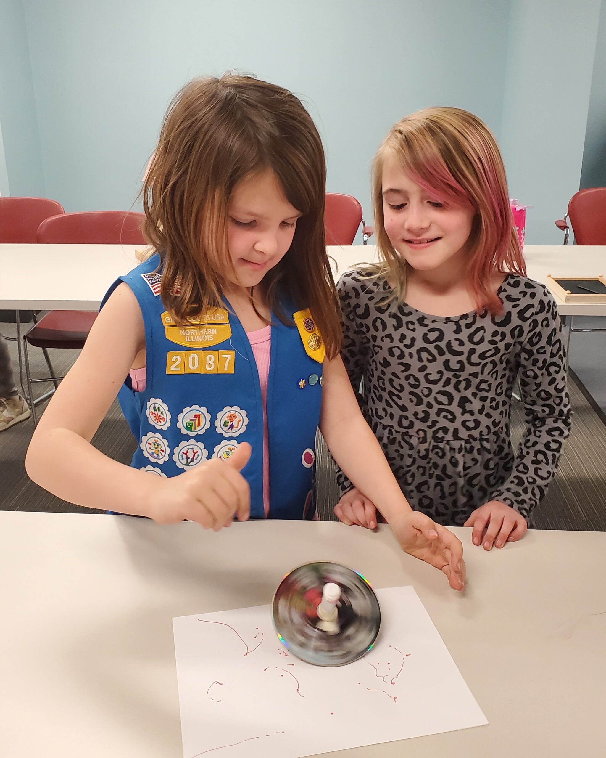 Two Girl Scouts working on their Craft and Tinker badge.