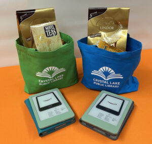 Adult prize bags for Library Card Sign-Up Month include a Kindle e-reader, tea and chocolate